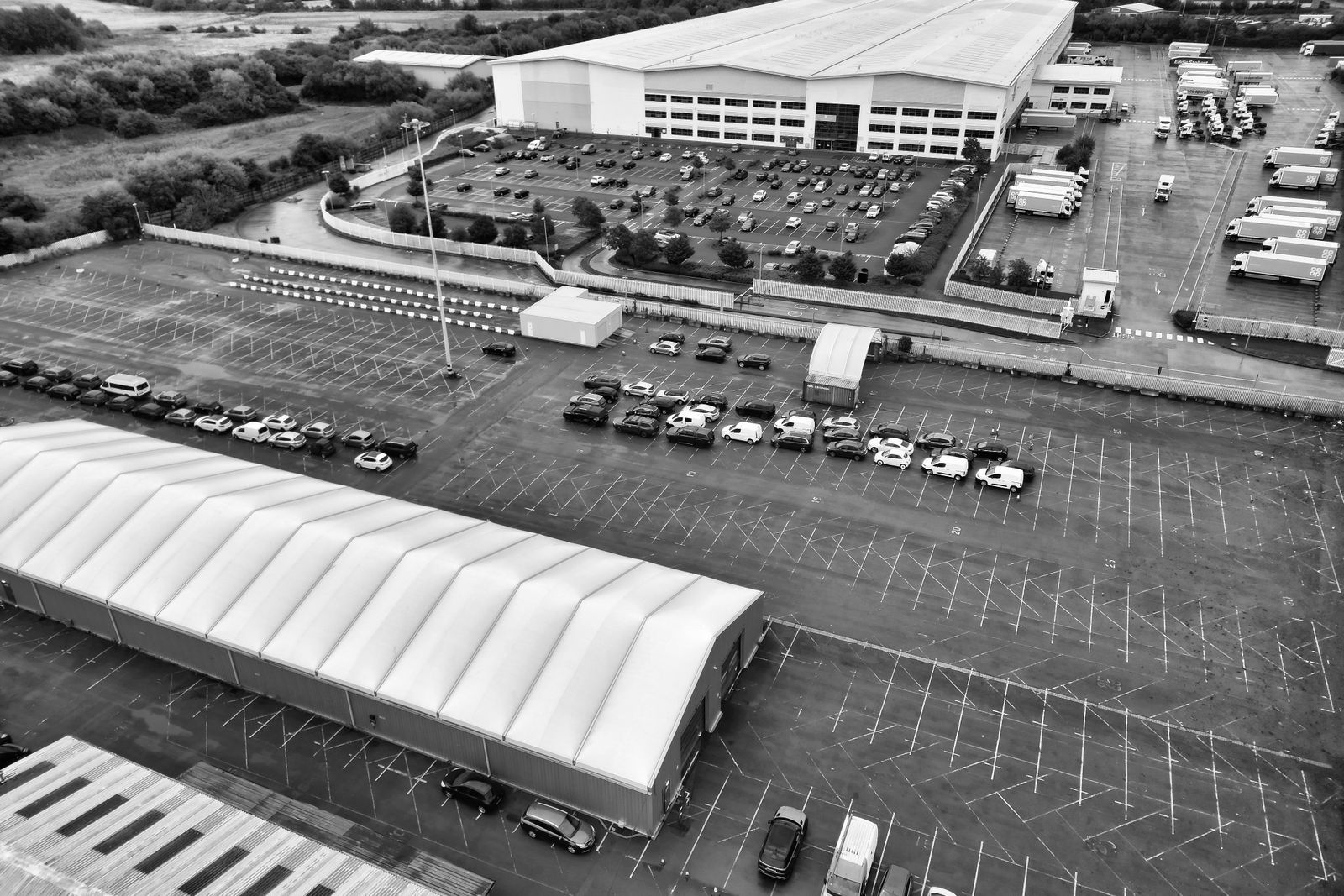 Aerial view of a large distribution warehouse with a truck yard
